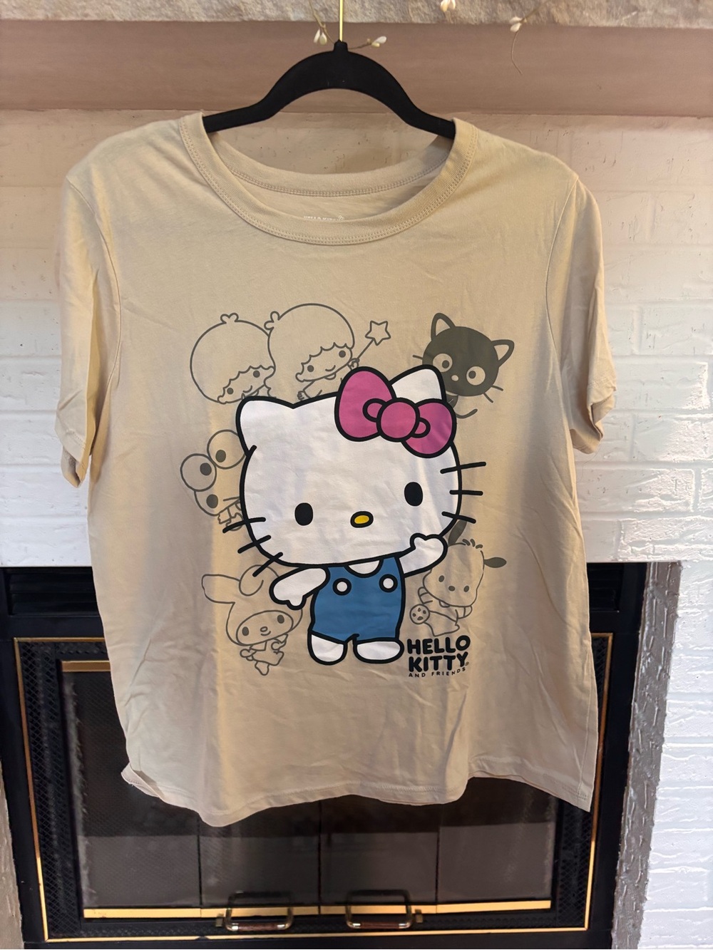 Sanrio Hello Kitty Cream Tee with Pink Bow and Blue Overalls Graphic